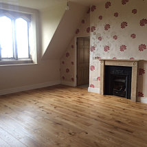 Bedroom with Ted Todd brushed Rustic Oak with a UV lacquer finish fireplace detail.